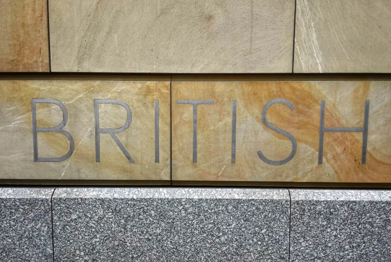 an image of british sign mounted to the side of a building