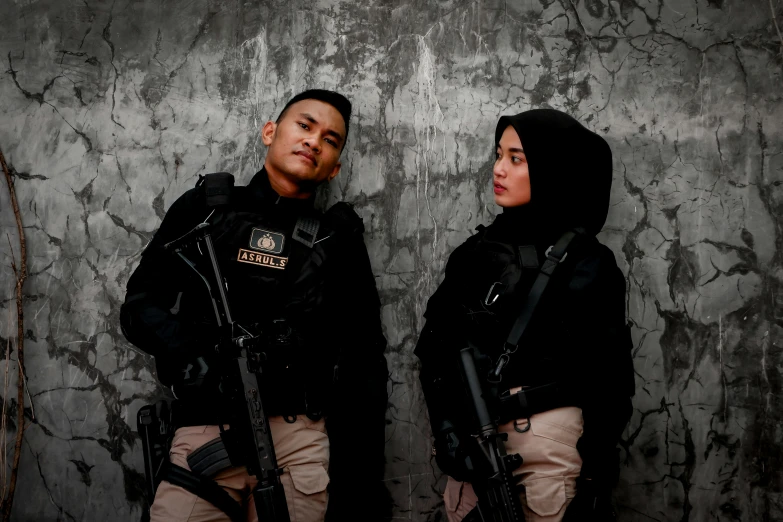 two people standing behind two large guns