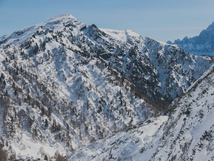 a group of skiers on top of a snowy mountain