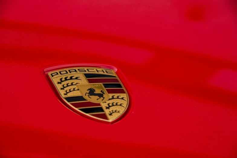 the badge on a red car shows it's shiny colors