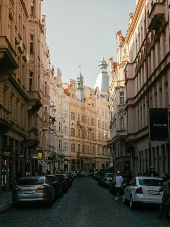 people walking down a street near many tall buildings