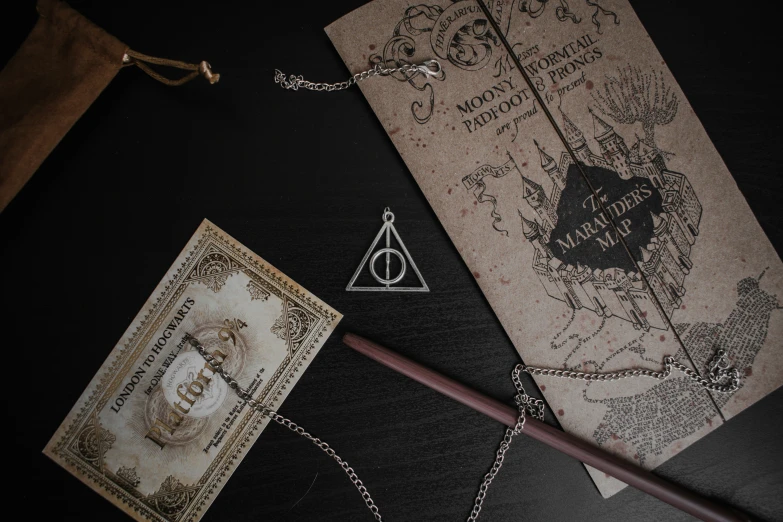 an old harry potter note, book, pen and stick