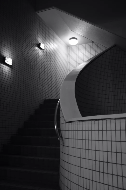 the stairwell with white tile and the tiled wall