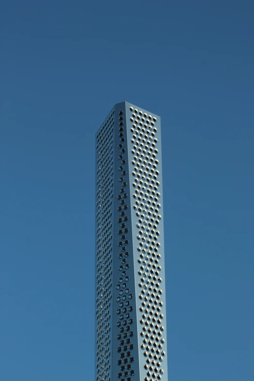 tall building next to clock tower against blue sky