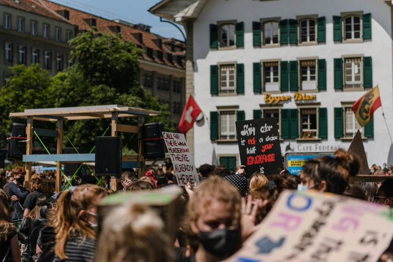 a large crowd of people walking along the street