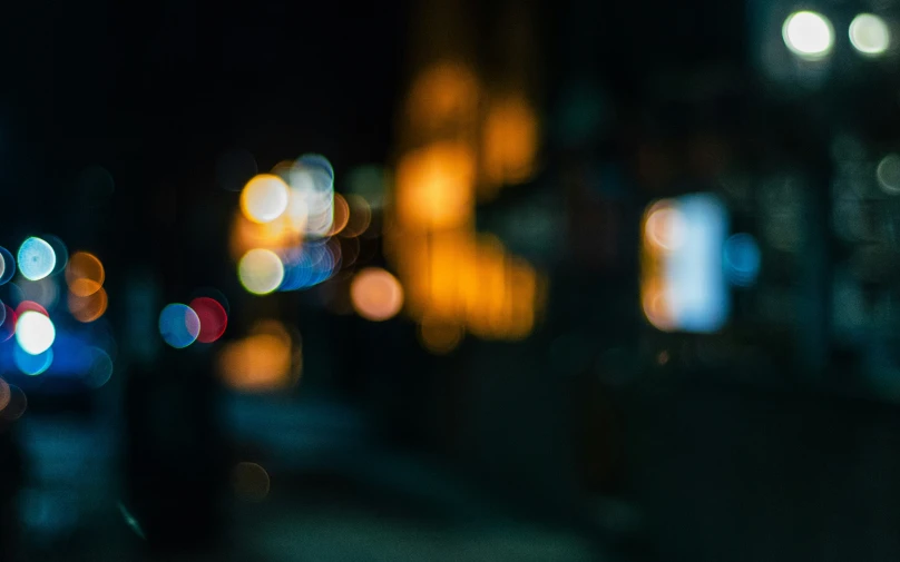 blurry lights at night with street and buildings in background