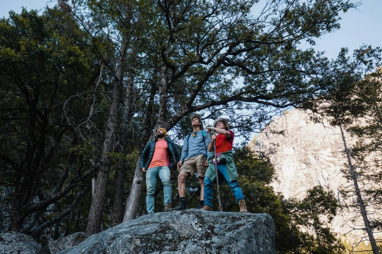 some people on a rock looking in the sky