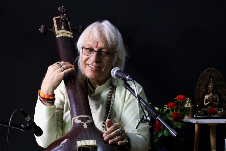 an old lady that is holding a large instrument