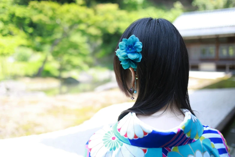 back view of woman's head with flowers on her hair