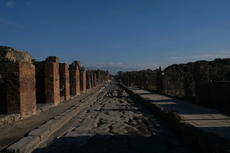 ancient street in middle of brick walls, with sky above