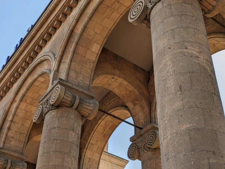 a building with two massive columns in the background