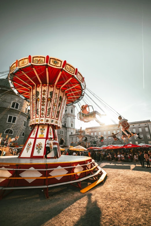 a carnival carousel sitting in front of some buildings