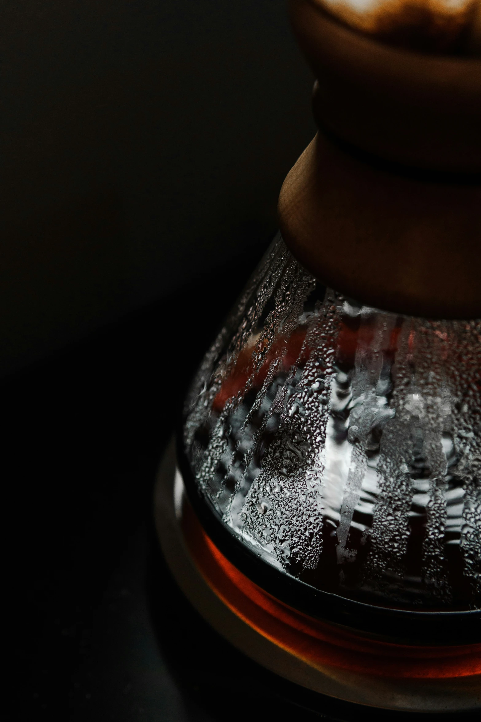 the bottom of a vase with some water inside