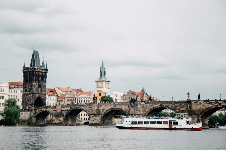 a boat is out on the water under a bridge