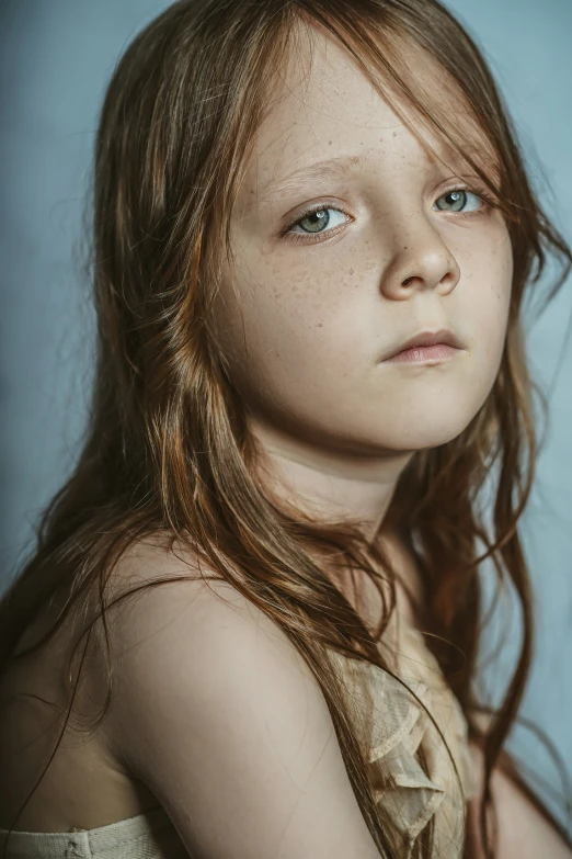 a little girl posing with frecked hair