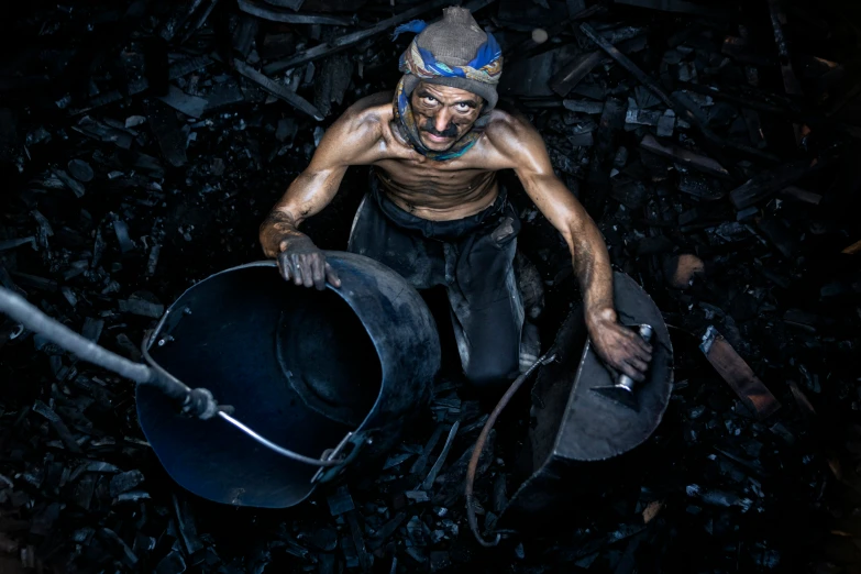 a man wearing a clown face and holding an iron pot