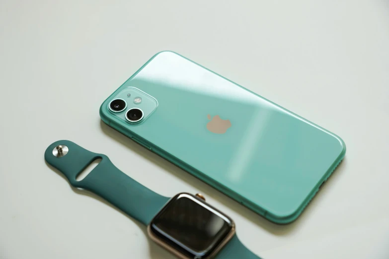 an apple watch and cell phone next to each other