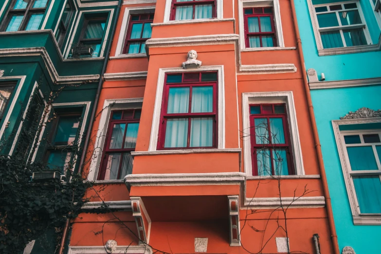 colorful old apartment buildings with red, blue, and green windows