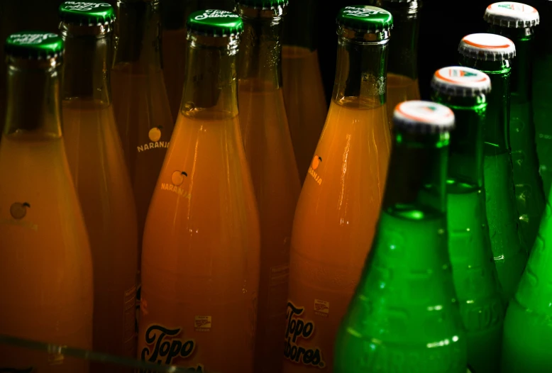 there are several bottles of sparkling beer in rows