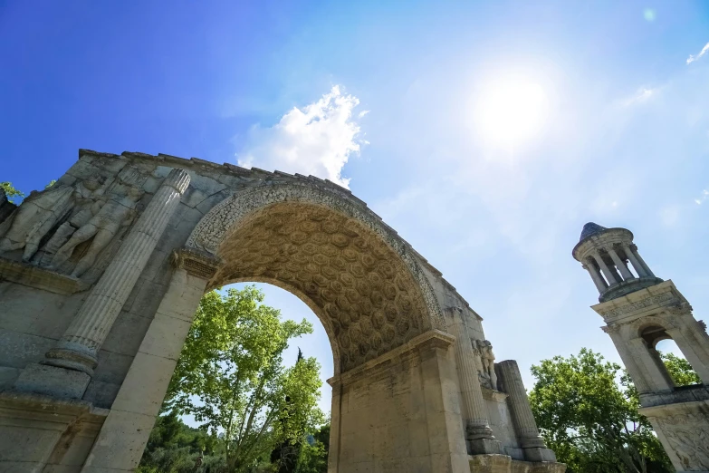 the sun shines through two arched arches