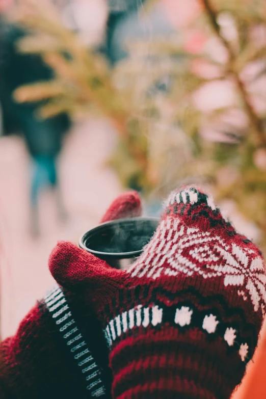 socks placed on a coffee cup outside a shop