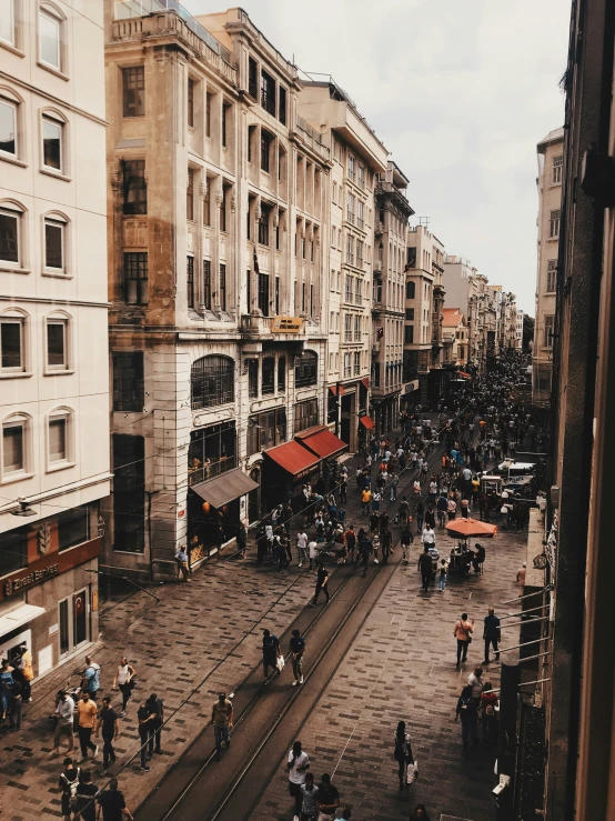 many people standing near many buildings in the city