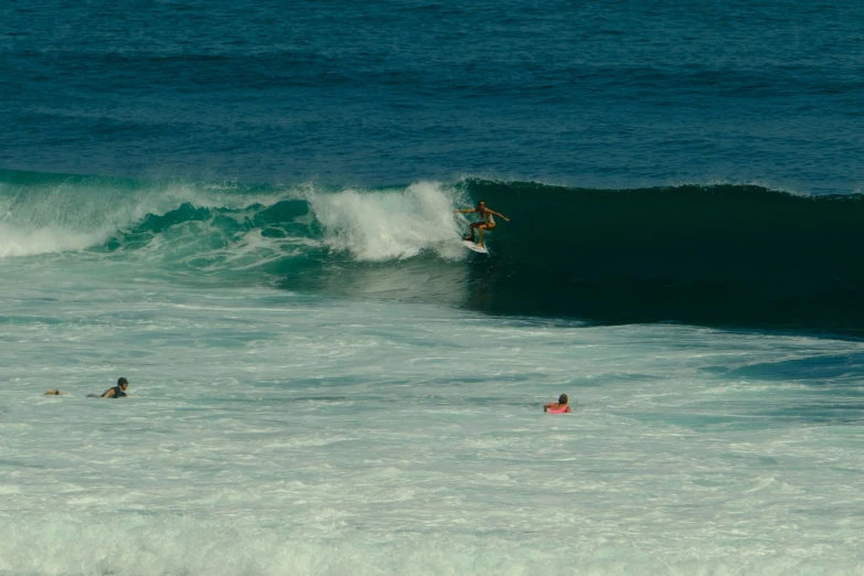 a surfer rides a wave on the ocean