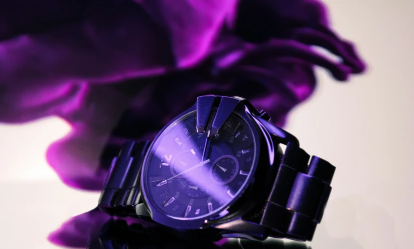close up view of watch with purple flowers in the background