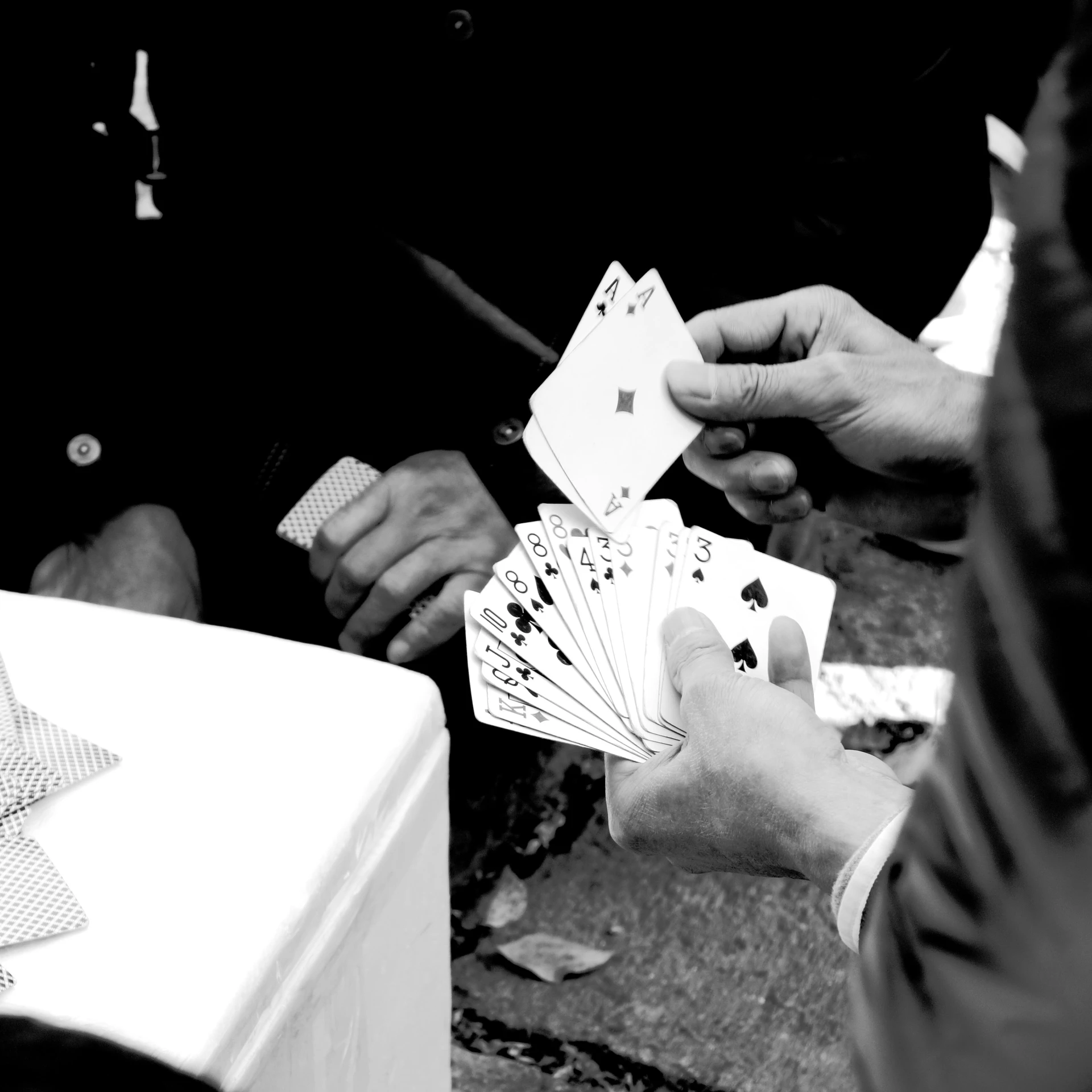 a person holding out four cards in their hands
