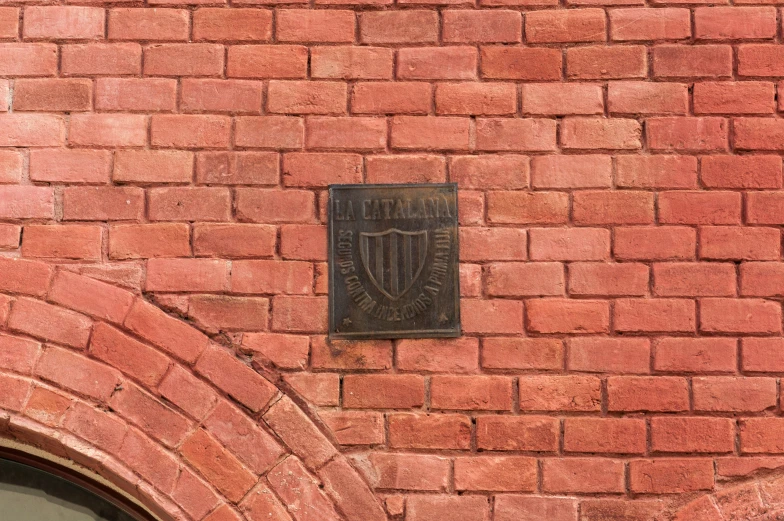 a brick wall with a plaque on it