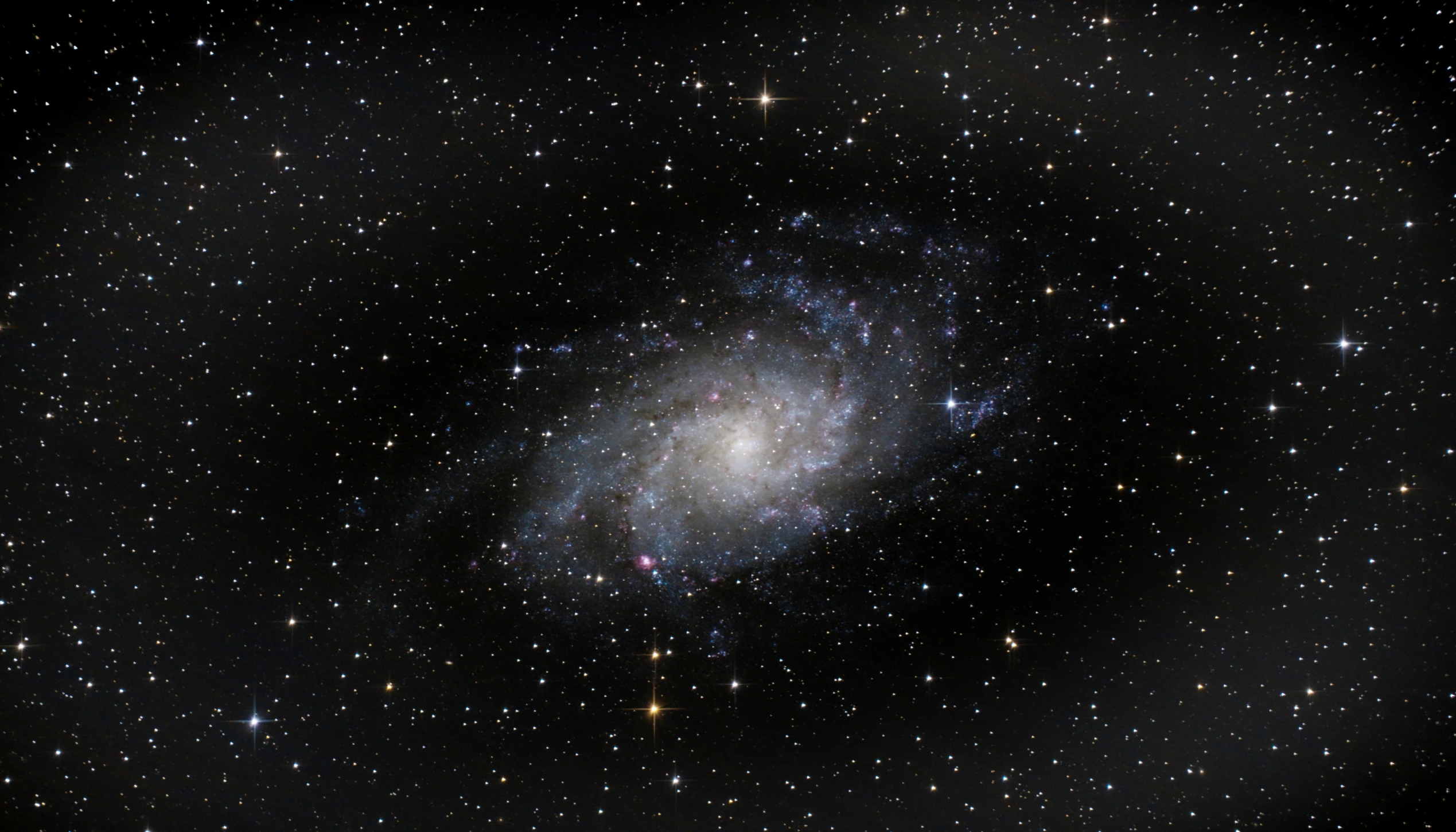 the image shows a spiral shape, and stars are in the background