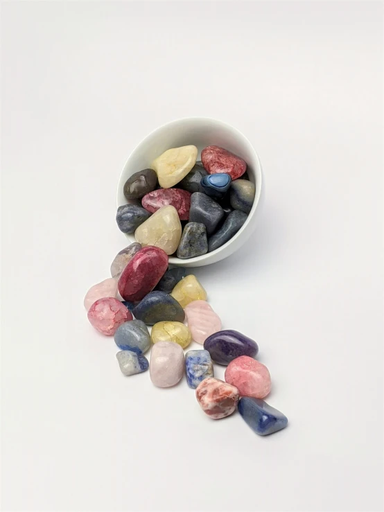 a bowl filled with small stones sitting on top of a table