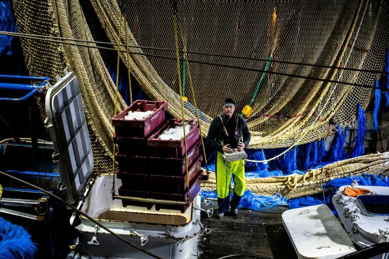 a couple of men standing next to each other on a boat