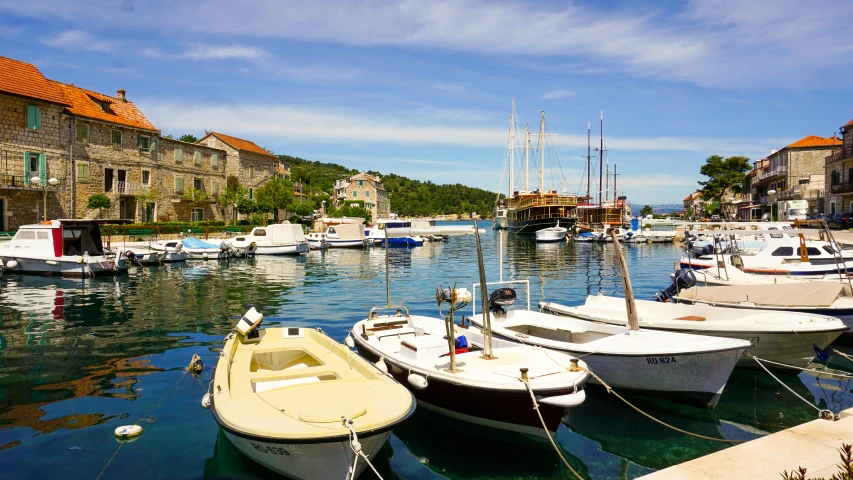 several small boats are anchored in a harbor