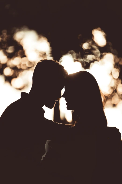 a silhouette po of a man and woman who are kissing