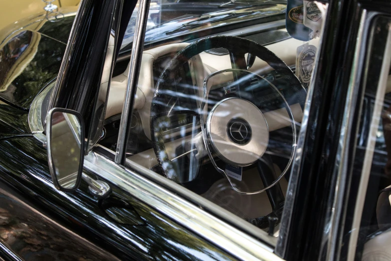 a reflection of some old cars on the side mirror