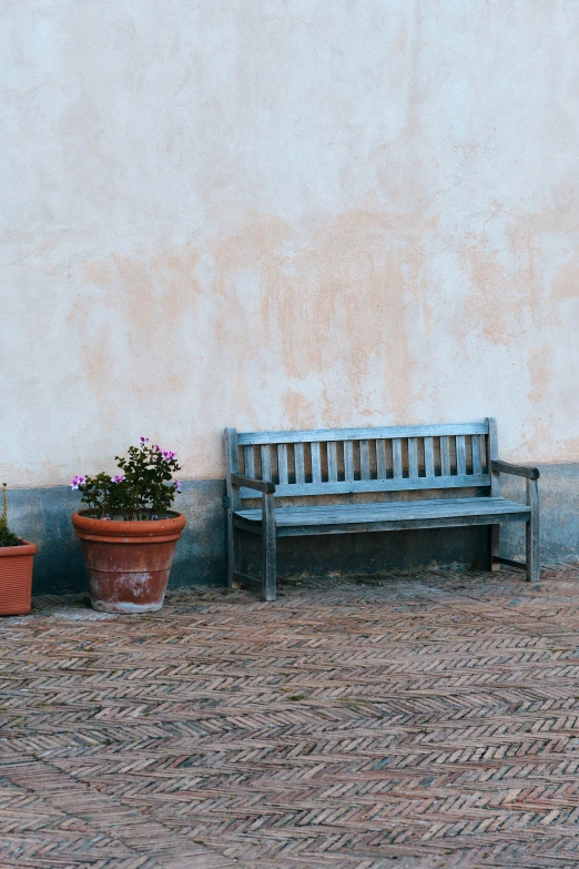 a bench is sitting in front of a wall