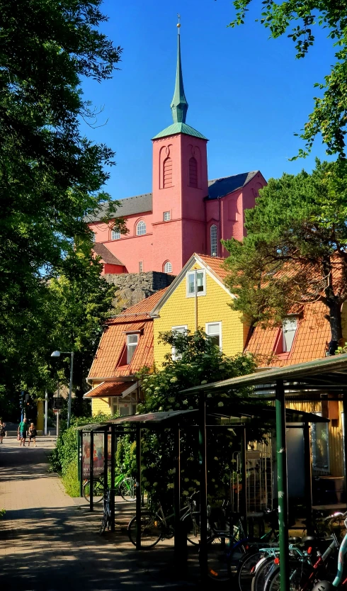 a street view of buildings with a church on the top of one