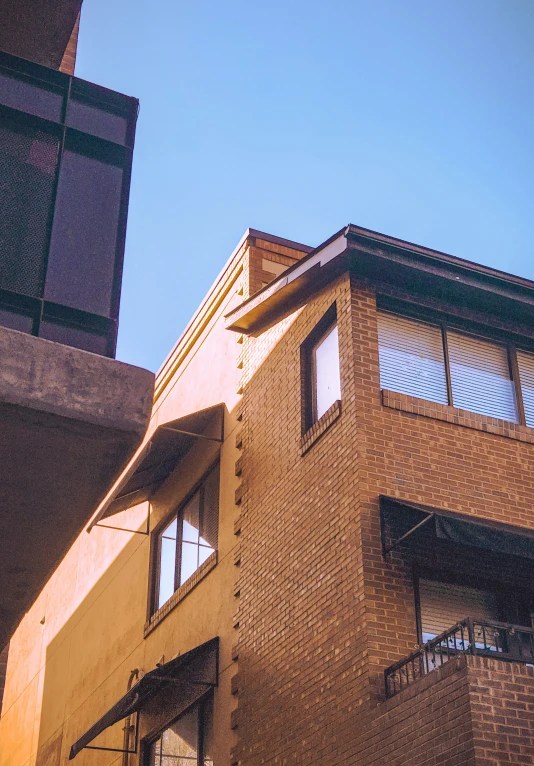 a tall brick building with windows and balconies