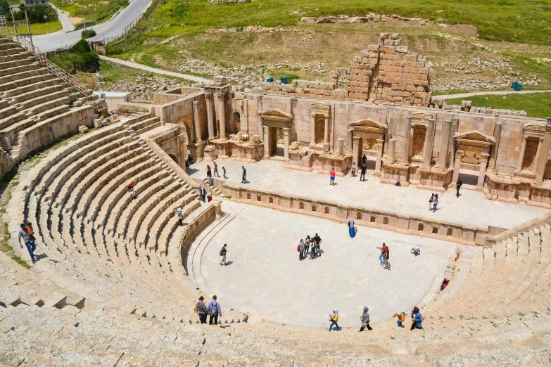 aerial view of people standing in the ruins of a roman theater