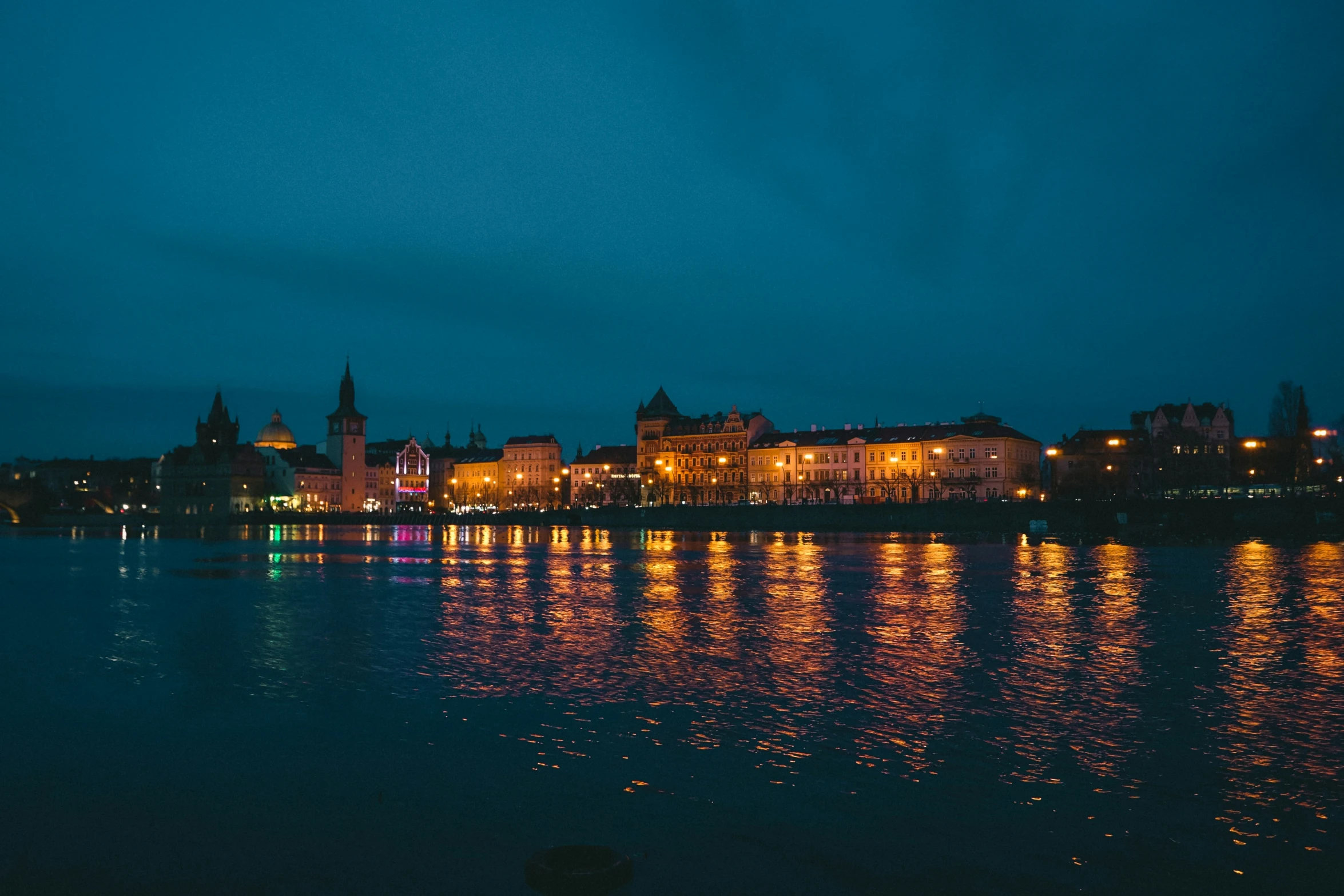 several lights shine brightly on the water