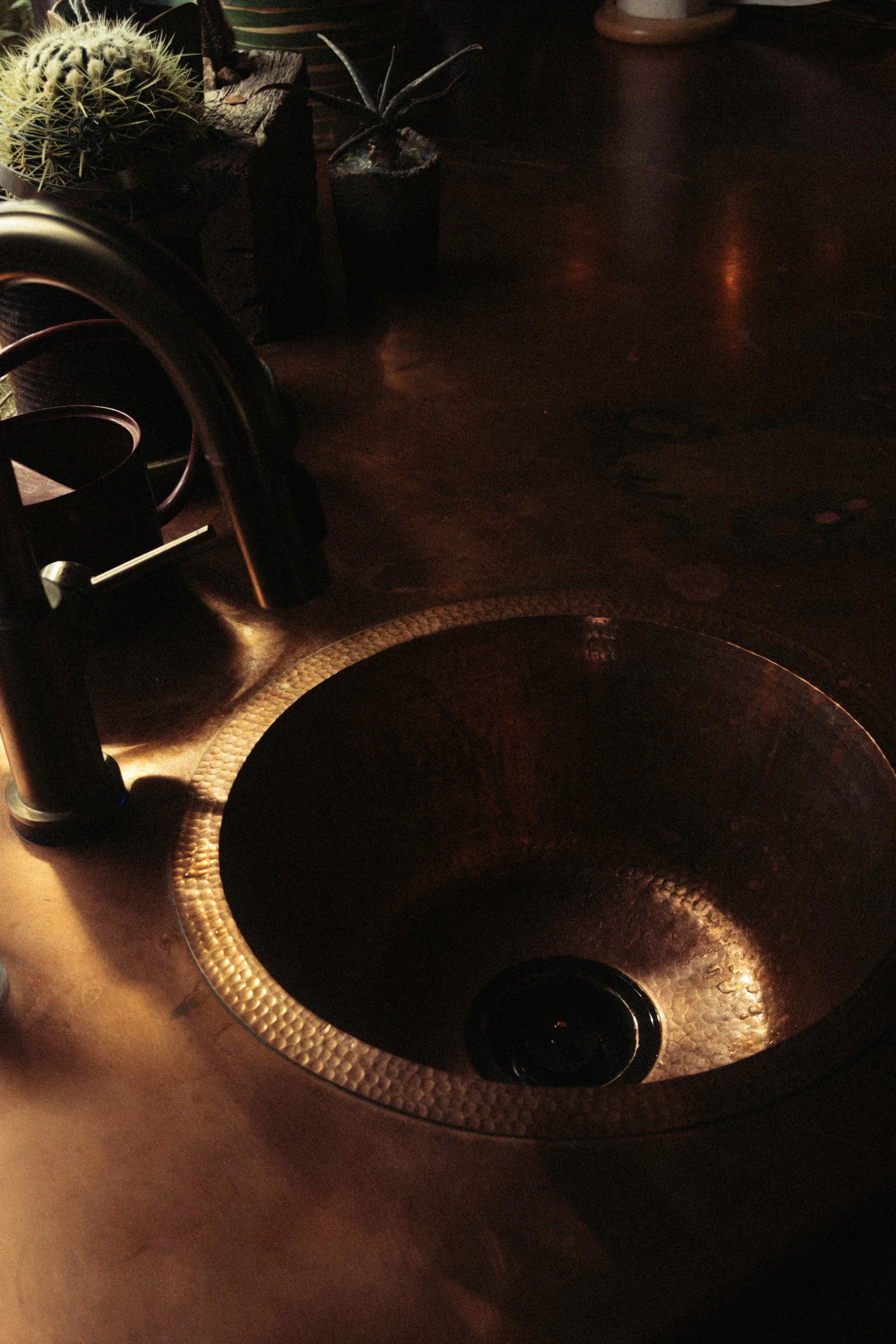 a bathroom sink on a wood floor with no lighting in it