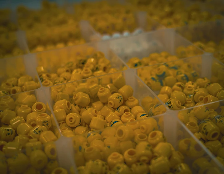 a box filled with lots of tiny yellow beads