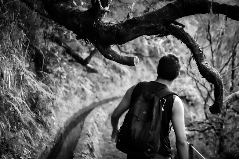 the man with the back pack is standing on the path