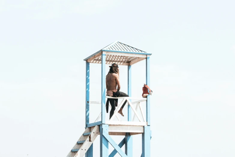 a person is standing at the top of a lifeguard tower