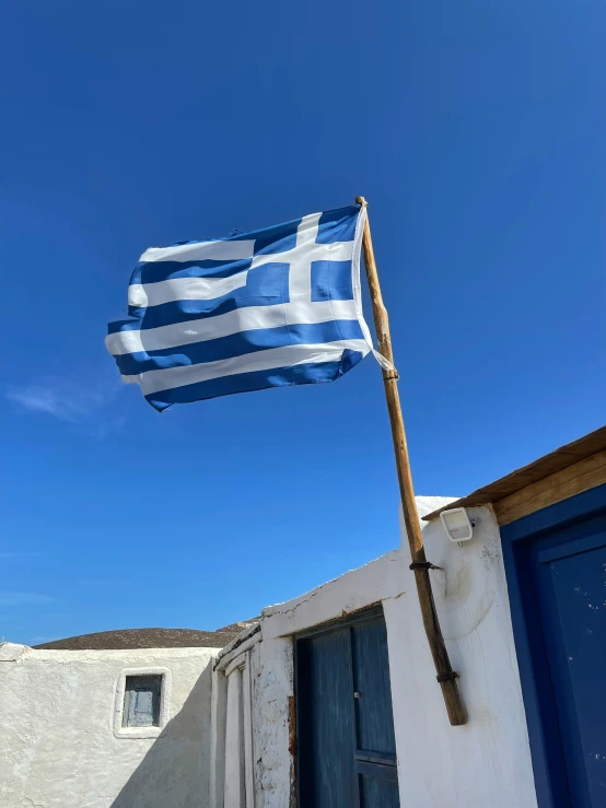 an israeli flag is blowing on top of a building