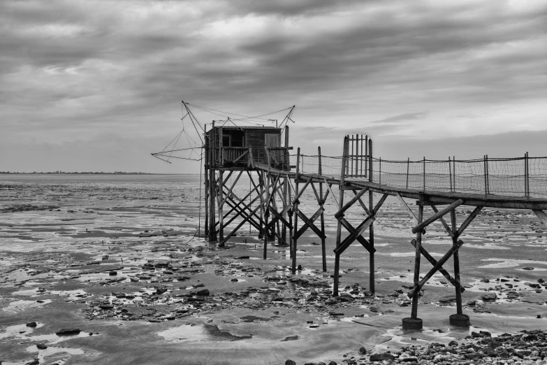 a black and white po of an old wooden pier