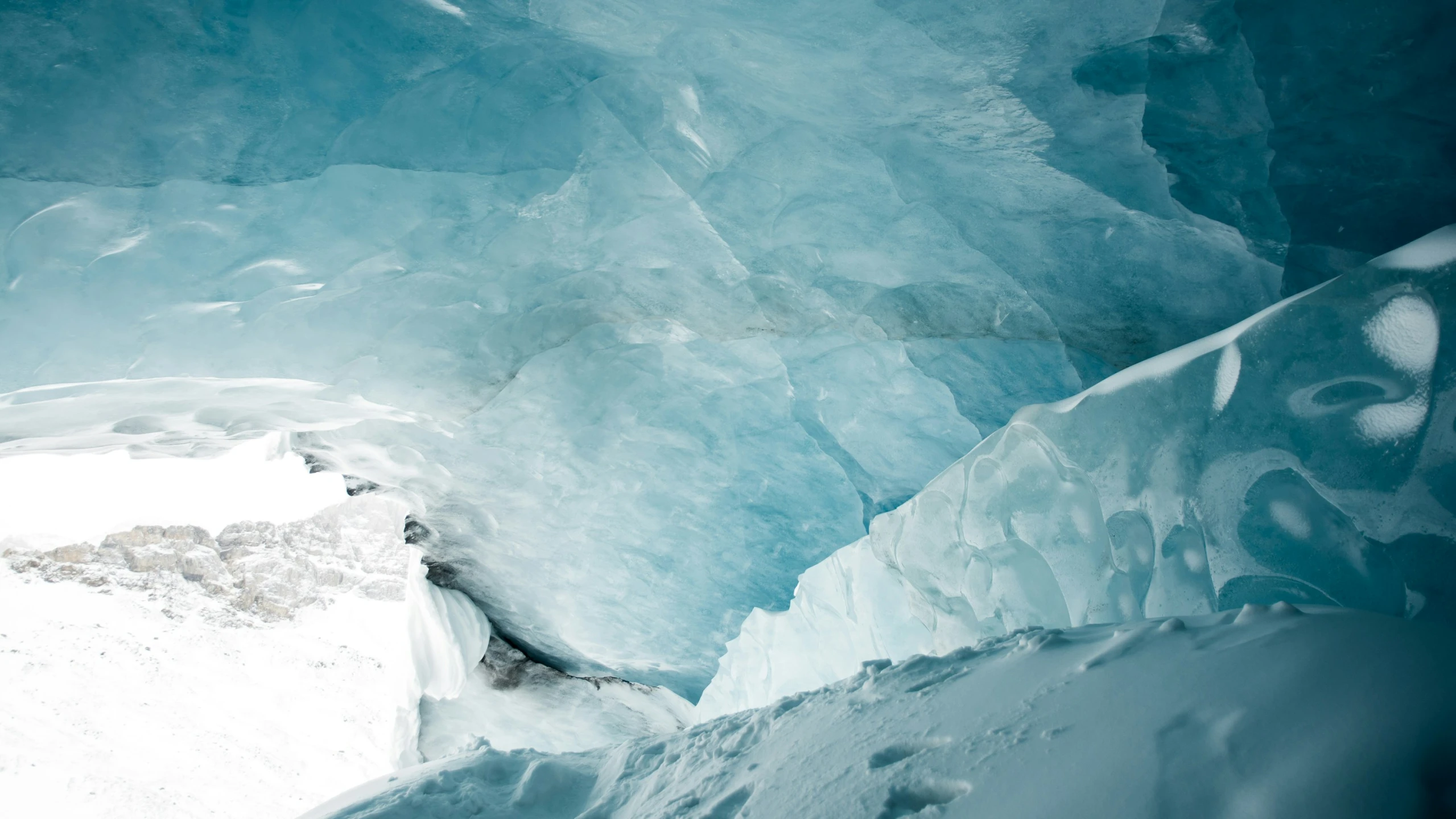 view from inside an ice cave with water and snow