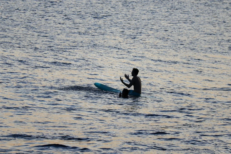 the man is riding his surfboard alone in the ocean