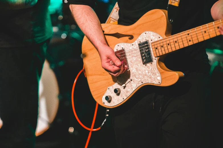 a close up of a person playing with a guitar